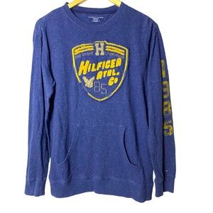 Tommy Hilfiger Heather Blue crew long sleeve shirt with 1985 down left sleeve.